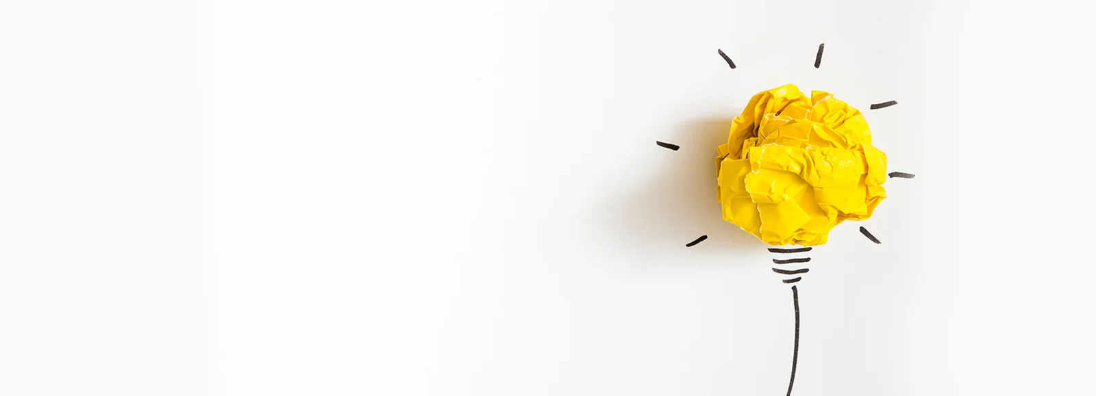 A crumpled paper light bulb — the spark of an idea